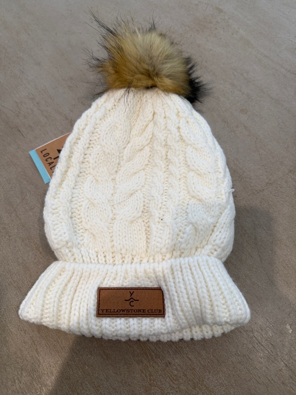 Yellowstone Club Ivory Cable-Knit Beanie with Faux-Fur Pom by Locale